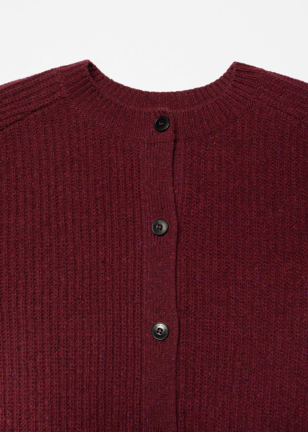 Close-up of a ribbed knit cardigan sweater in deep burgundy with three dark buttons, shown against a plain light background.