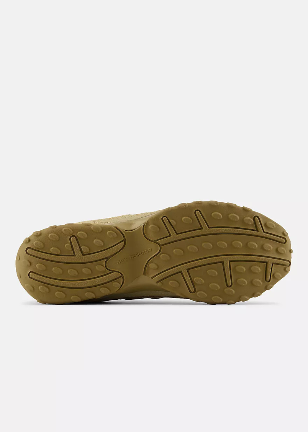 A close-up, top-down view of a brown textured rubber outsole, showing its grooved tread pattern and circular lugs, set against a plain light gray background.