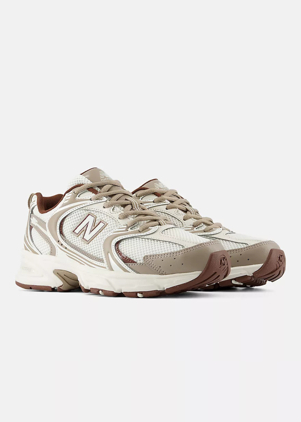A pair of New Balance sneakers in beige, cream, and brown, displayed against a light gray background.