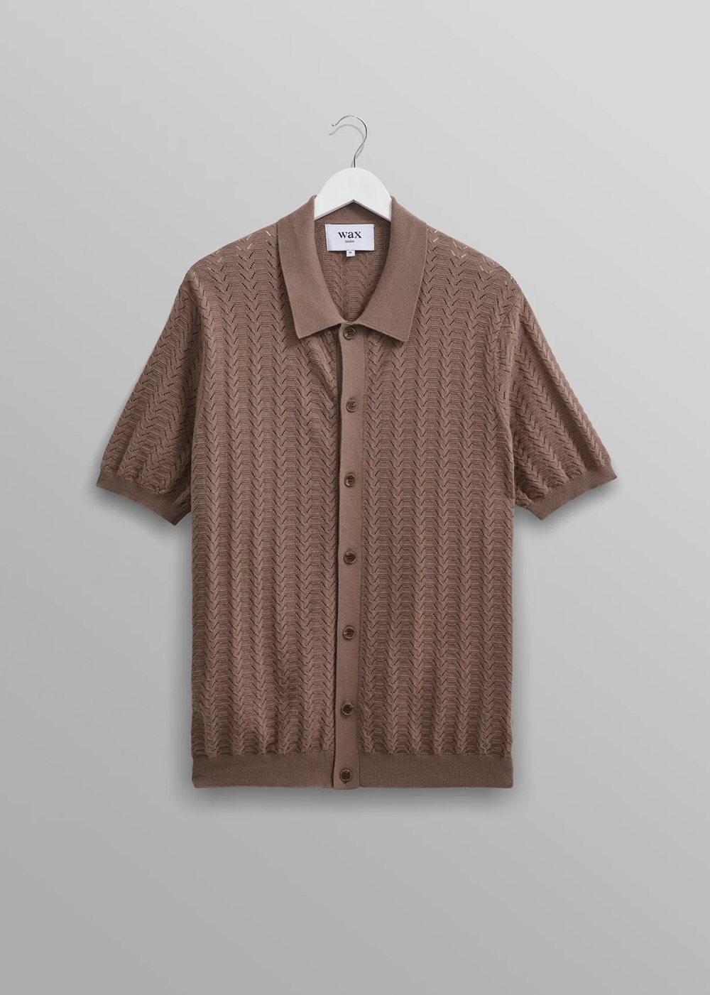 front view of the Tellaro Shirt by Wax London in Brown. It is a button through polo shirt with pointelle stitch detail and relaxed fit