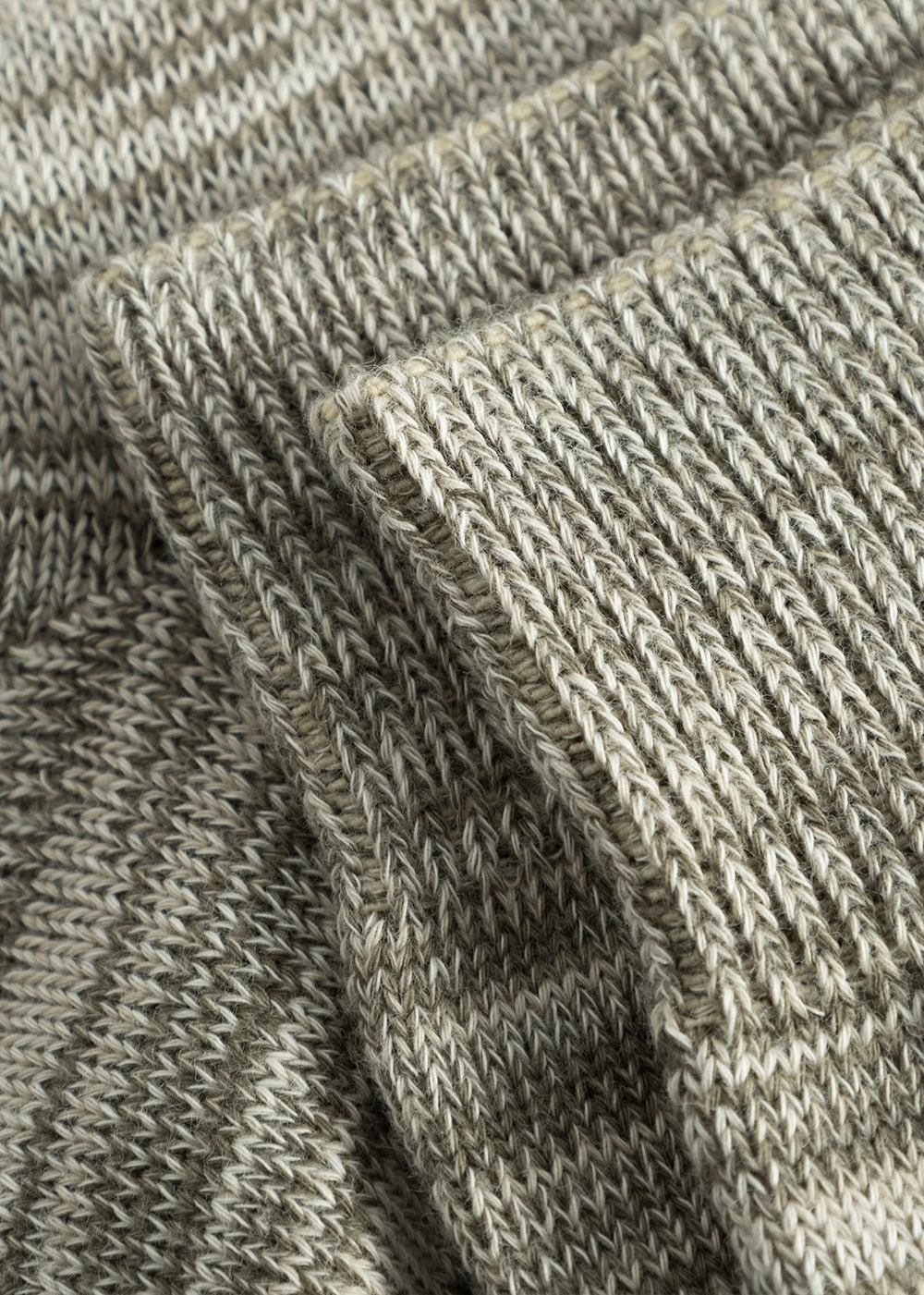 Close up view of the Bjarki Cotton Twist Sock in Sediment Green by Norse Projects, showcasing the detailed stitching in the sock.