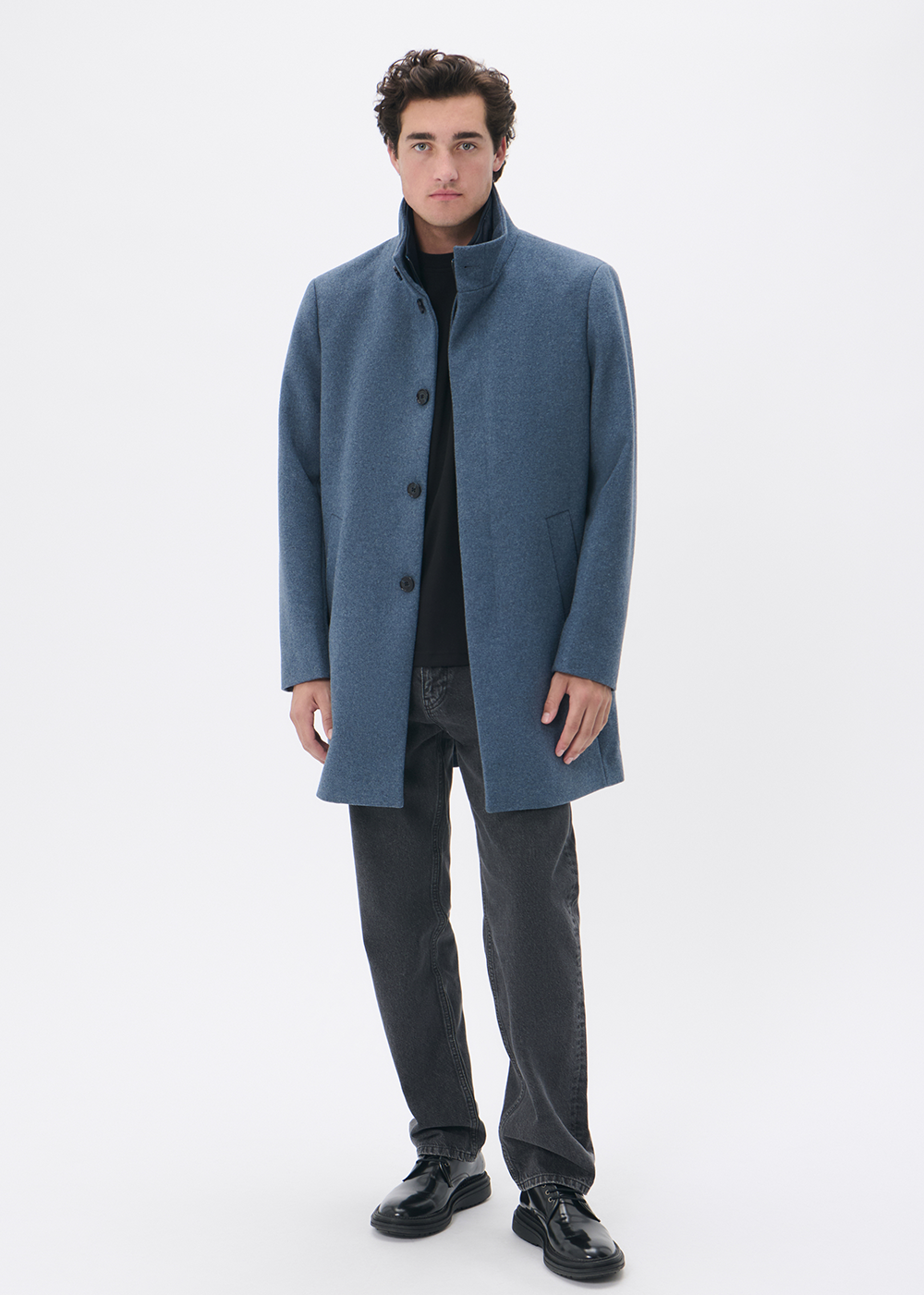 Man wearing a blue coat on a white background