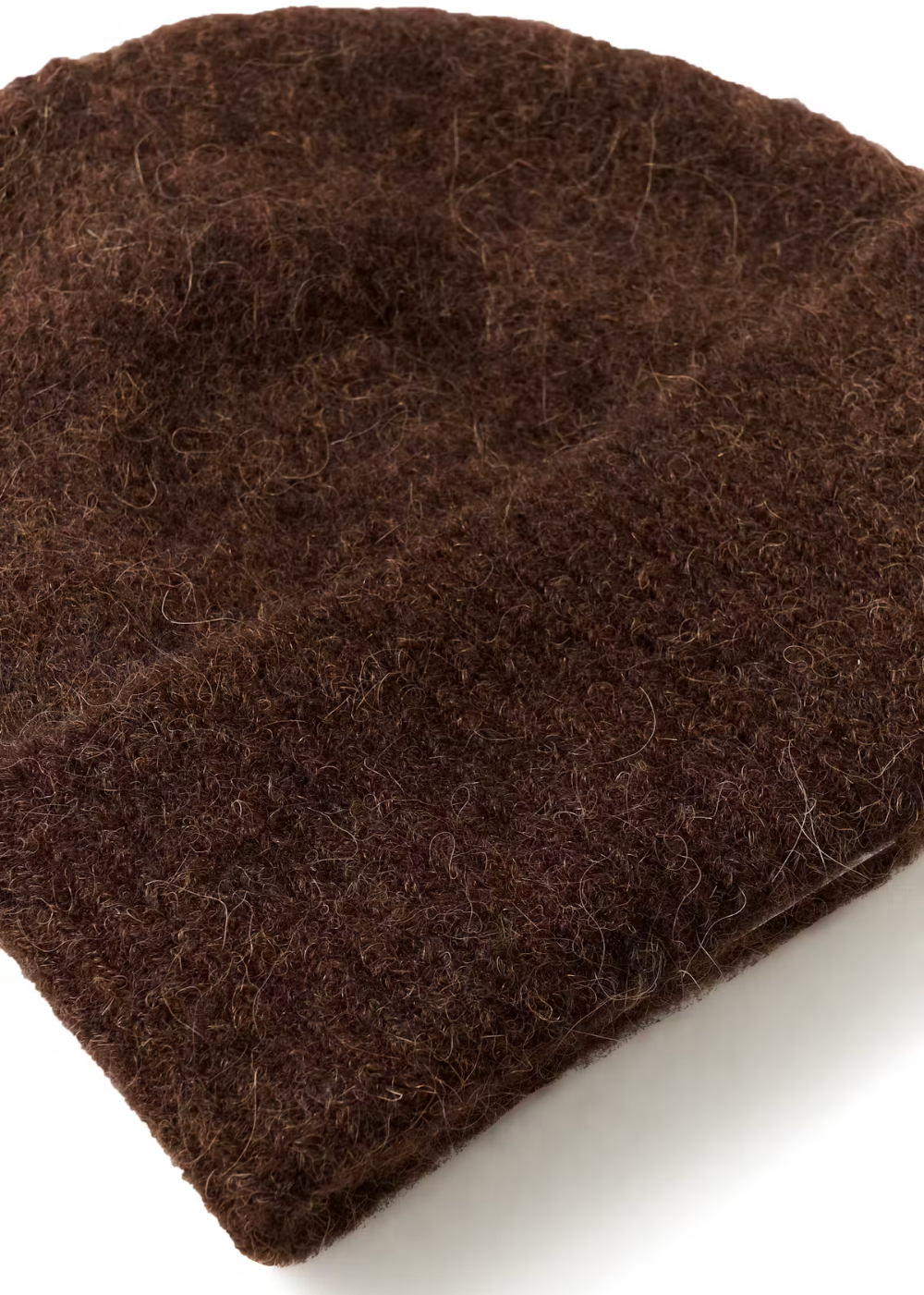 A close-up of a dark brown fuzzy felt fabric, showing its soft, textured surface on a white background.