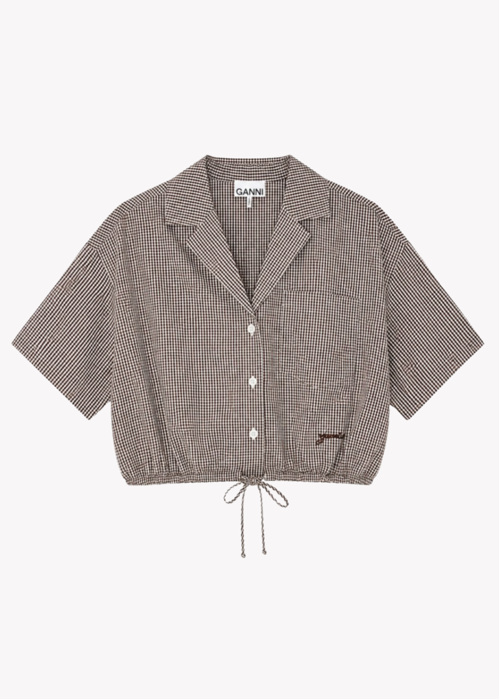A short-sleeve button-front shirt jacket by GANNI, featuring a brown and beige micro-check pattern, a pointed collar, and a drawstring hem, shown flat on a light gray background.