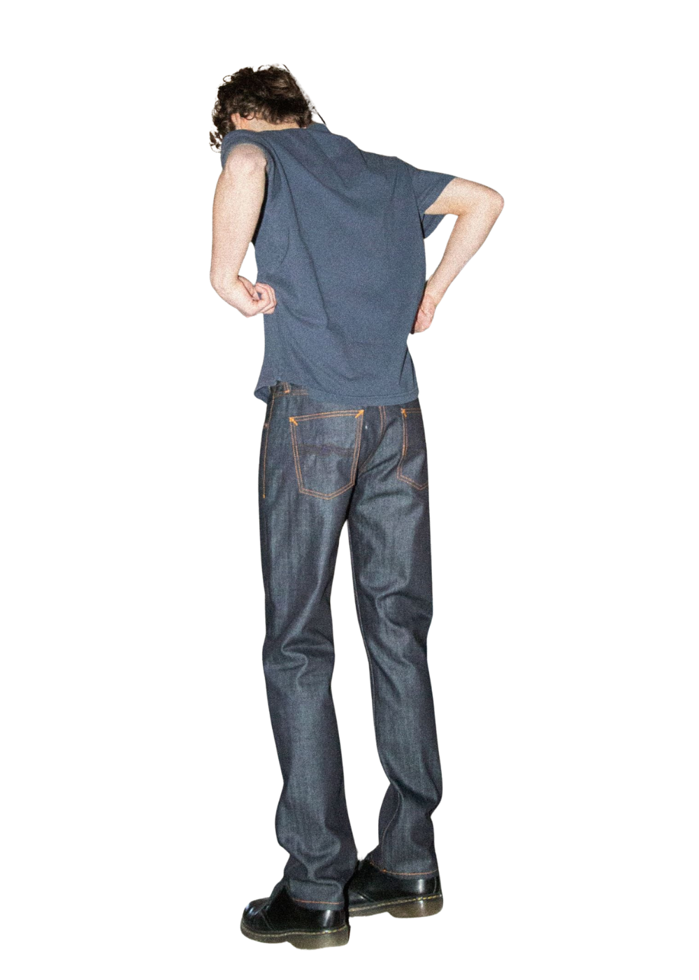 A man shown from the back wearing a dark blue sleeveless top, dark blue jeans, and black shoes, standing against a plain white background.