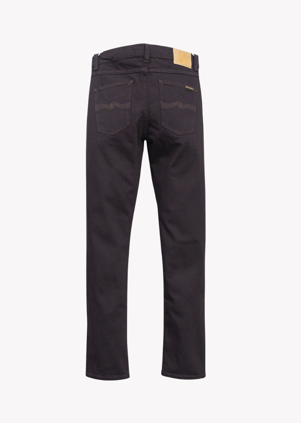 Rear view of dark brown gray slim-fit jeans with a small tan leather brand patch on the back waistband, displayed on a light gray background.