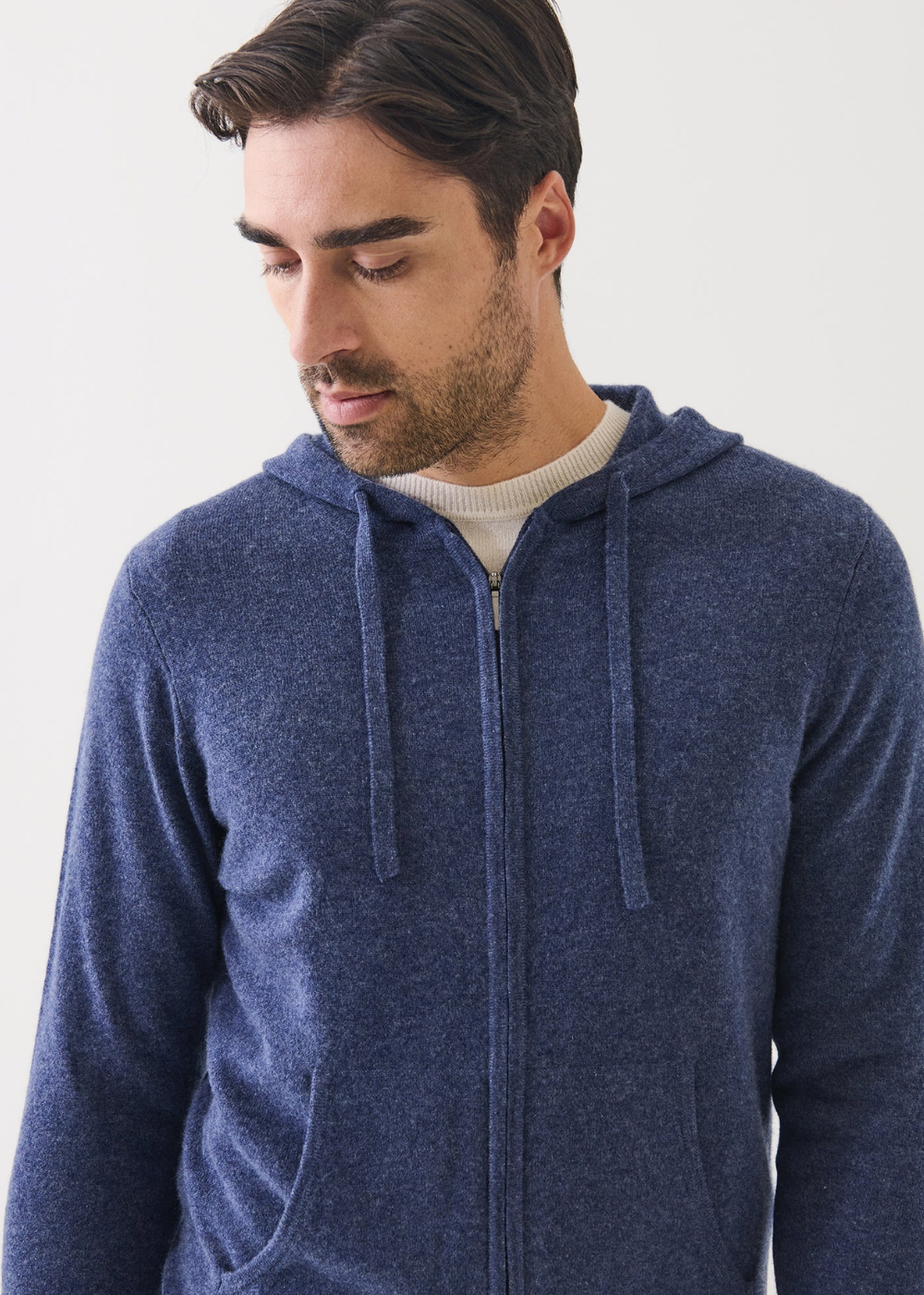 Man wearing a blue hoodie against a white background