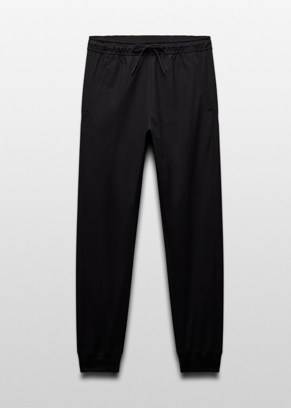 Black jogger pants with an elastic drawstring waistband and ribbed ankle cuffs, shown flat against a light gray background.