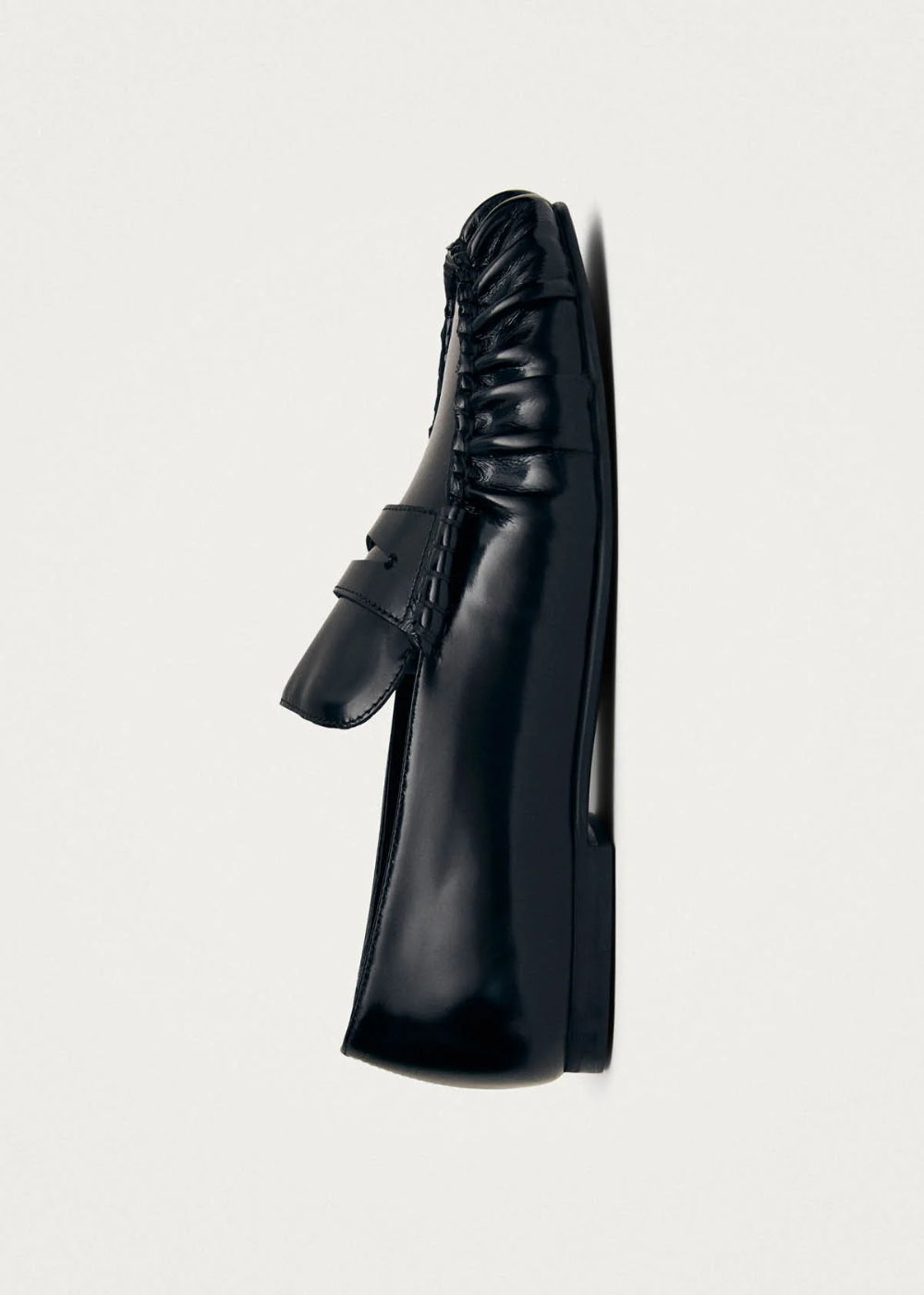 Black leather loafer on a white background