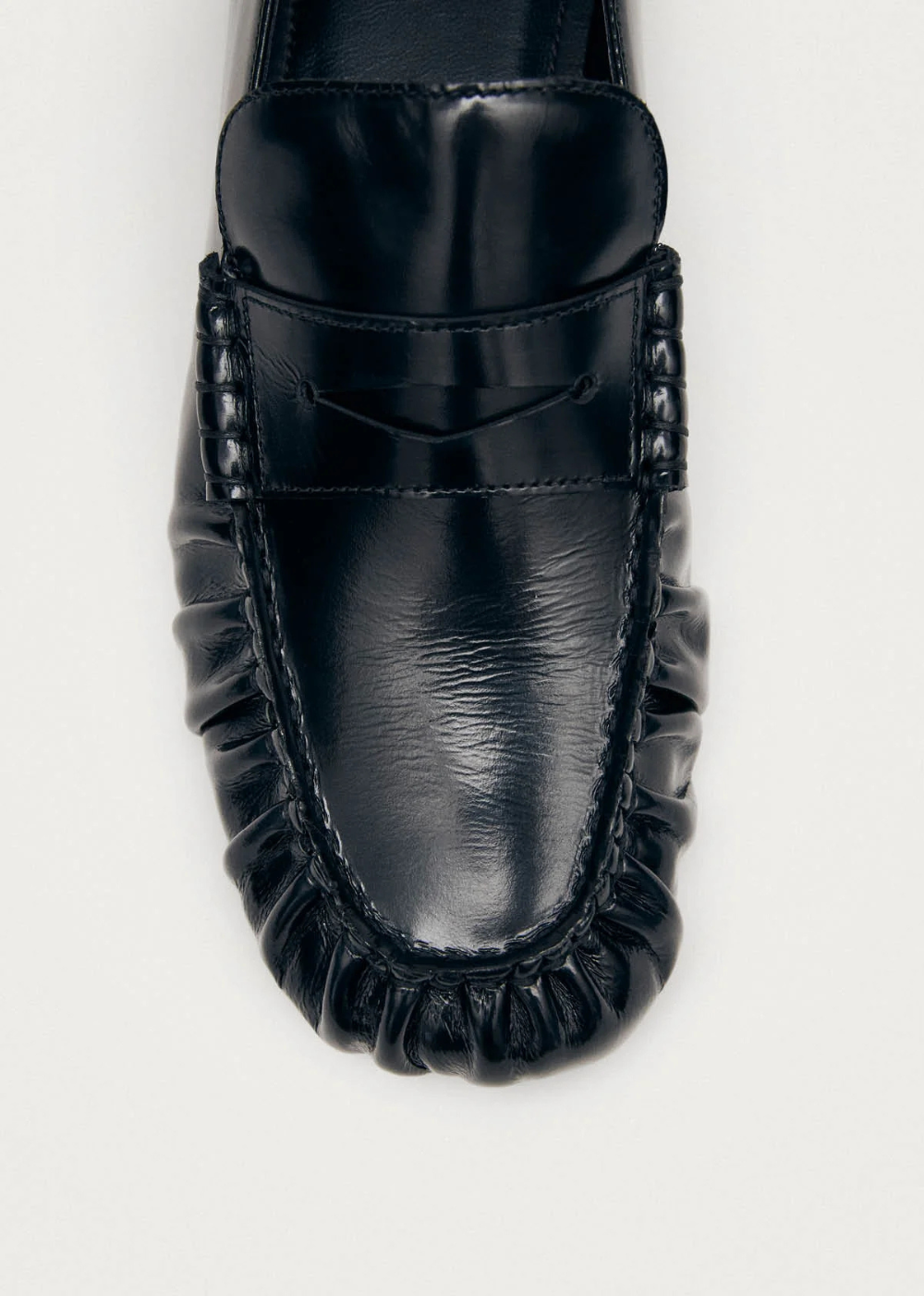 Black leather loafer on a white background