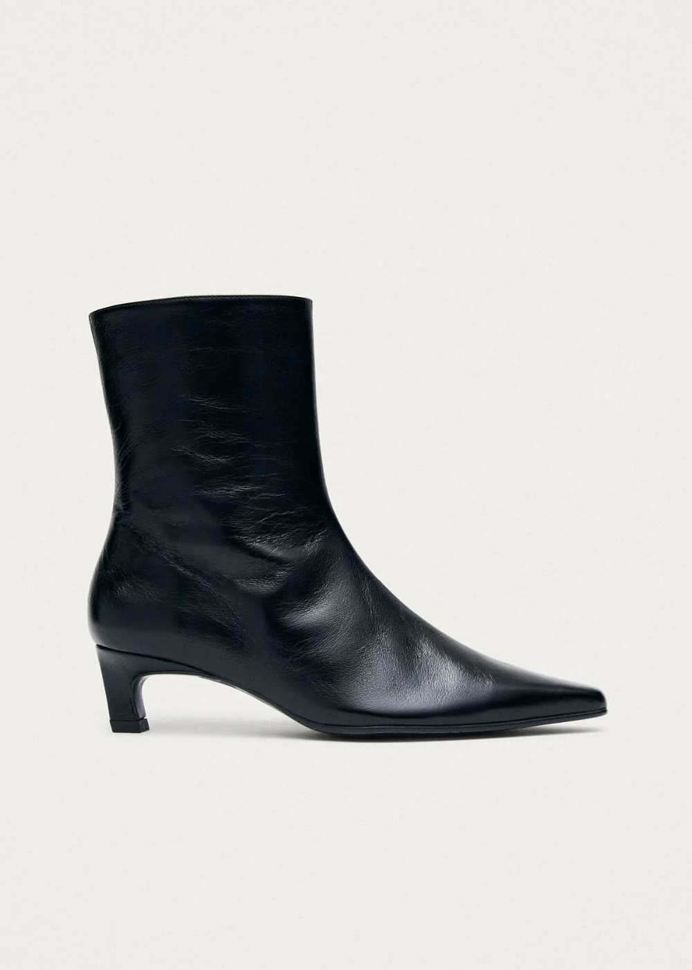 Black ankle boot on a light gray background