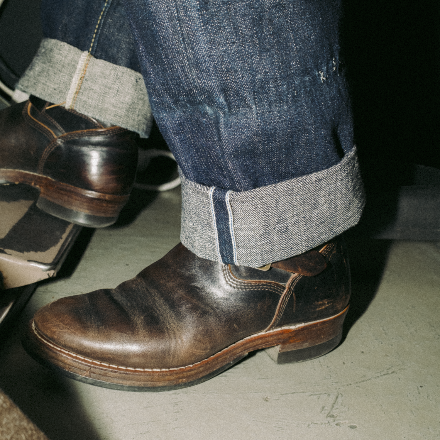 Close-up picture of a pair of selvedge denim with a rolled hem showing the selvedge ID