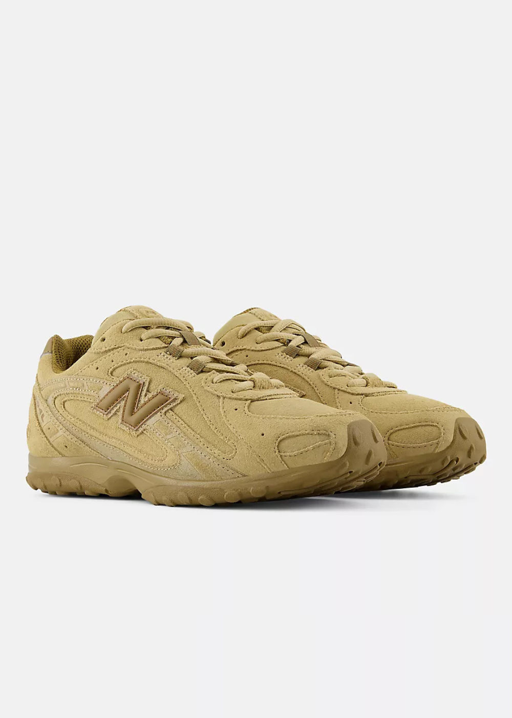 A pair of New Balance sneakers in a monochromatic tan/khaki colorway, featuring the signature 'N' logo on the side, set against a plain light gray background.