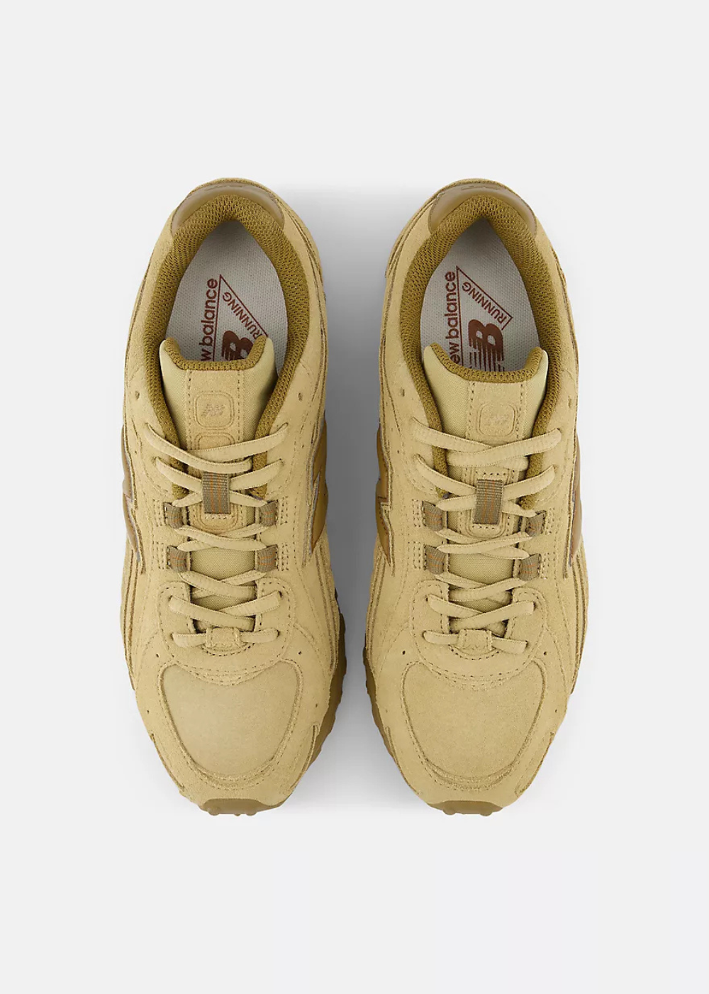 A pair of New Balance 204L sneakers in a monochromatic tan colorway, shown from a top-down view on a light gray background.