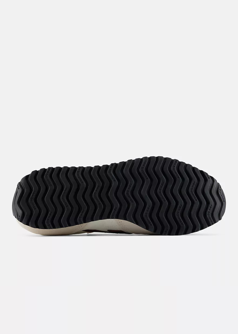 The black wavy-tread outsole of a sneaker, shown from a bottom-up view against a light gray background.