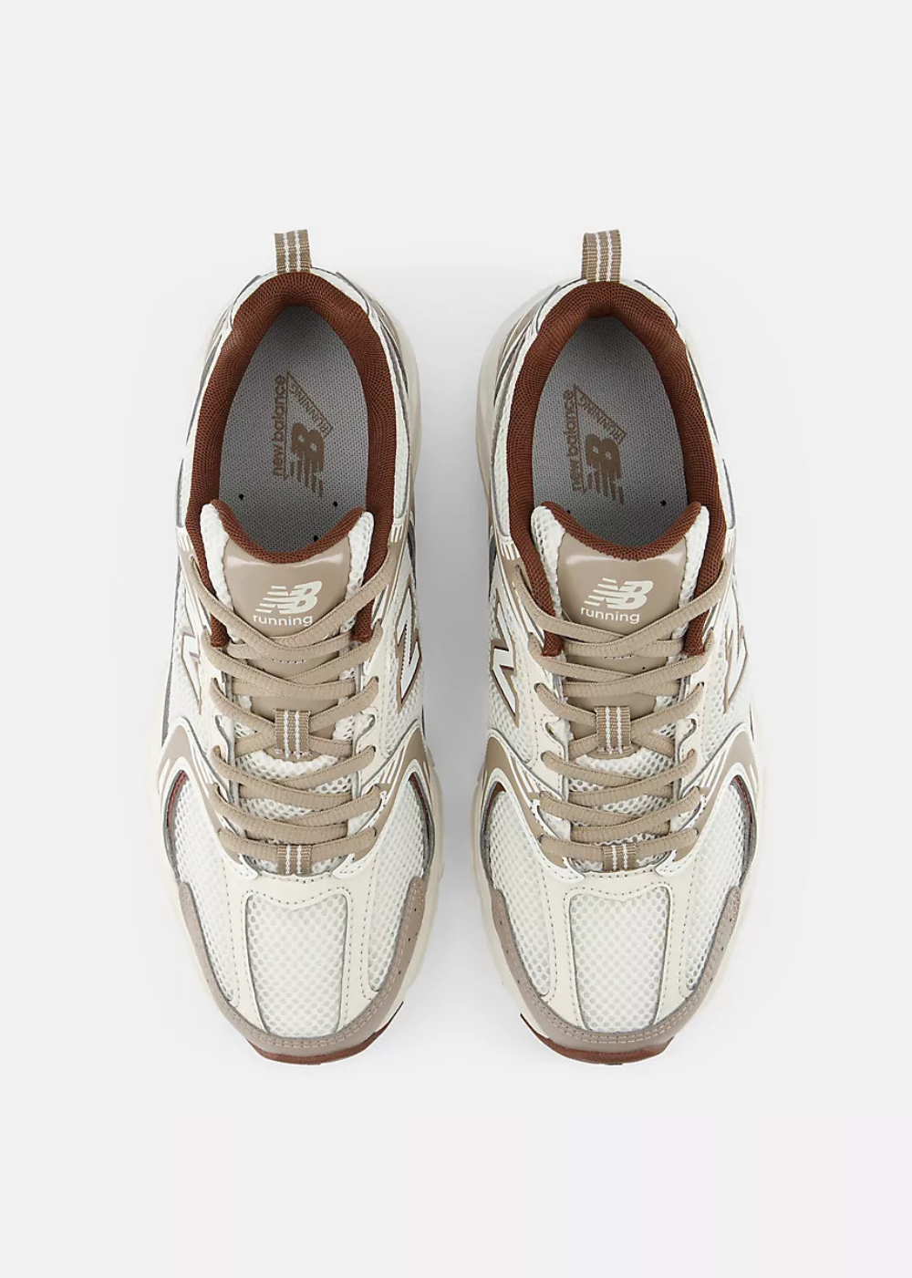 A pair of New Balance sneakers shown from a top-down view, featuring a cream and beige mesh and leather upper with metallic silver overlays and brown accents.