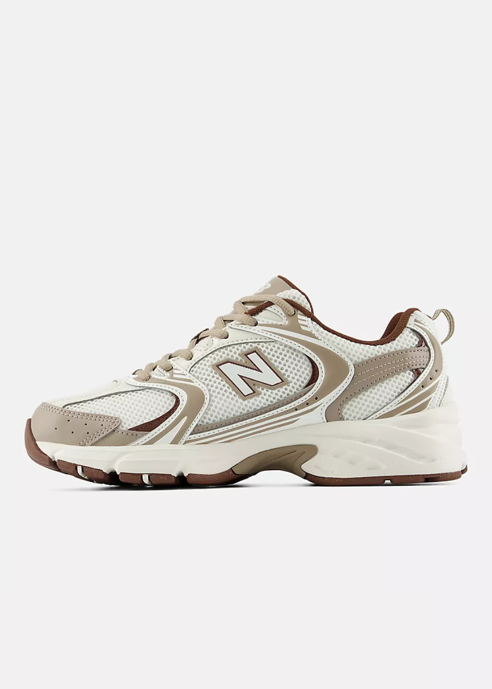 A New Balance chunky sneaker in beige, cream, and brown, shown from a side profile view against a light gray background.