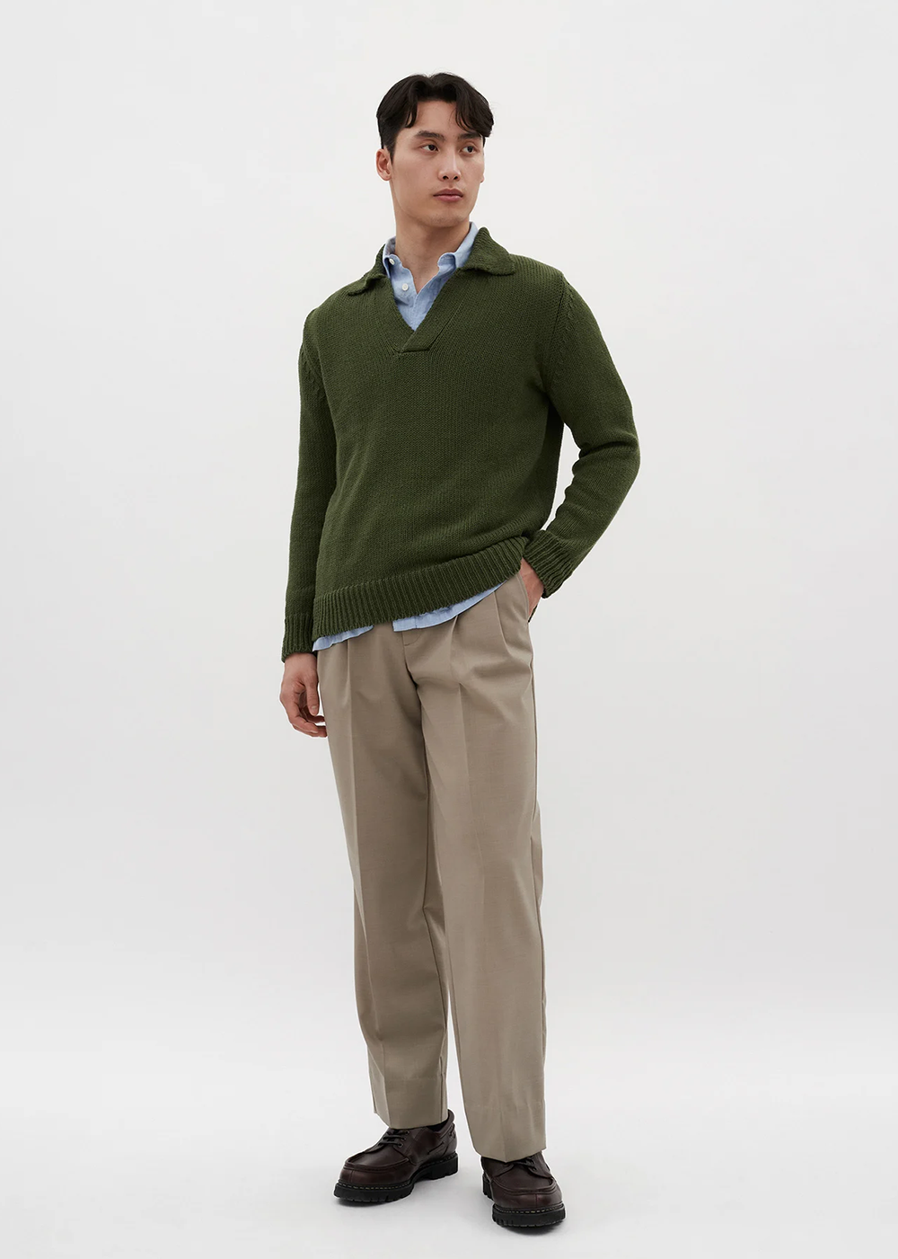 Full body front shot of a model wearing the Lasse Cotton Holiday Polo in Ivy Green by Norse Projects.
