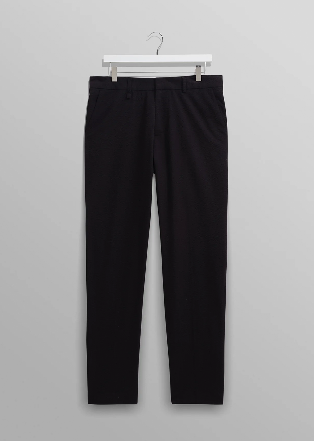 Front view of the Alp Trousers by Wax London in Black Seersucker. Straight leg, with, fixed waistband, and back welt pockets.
