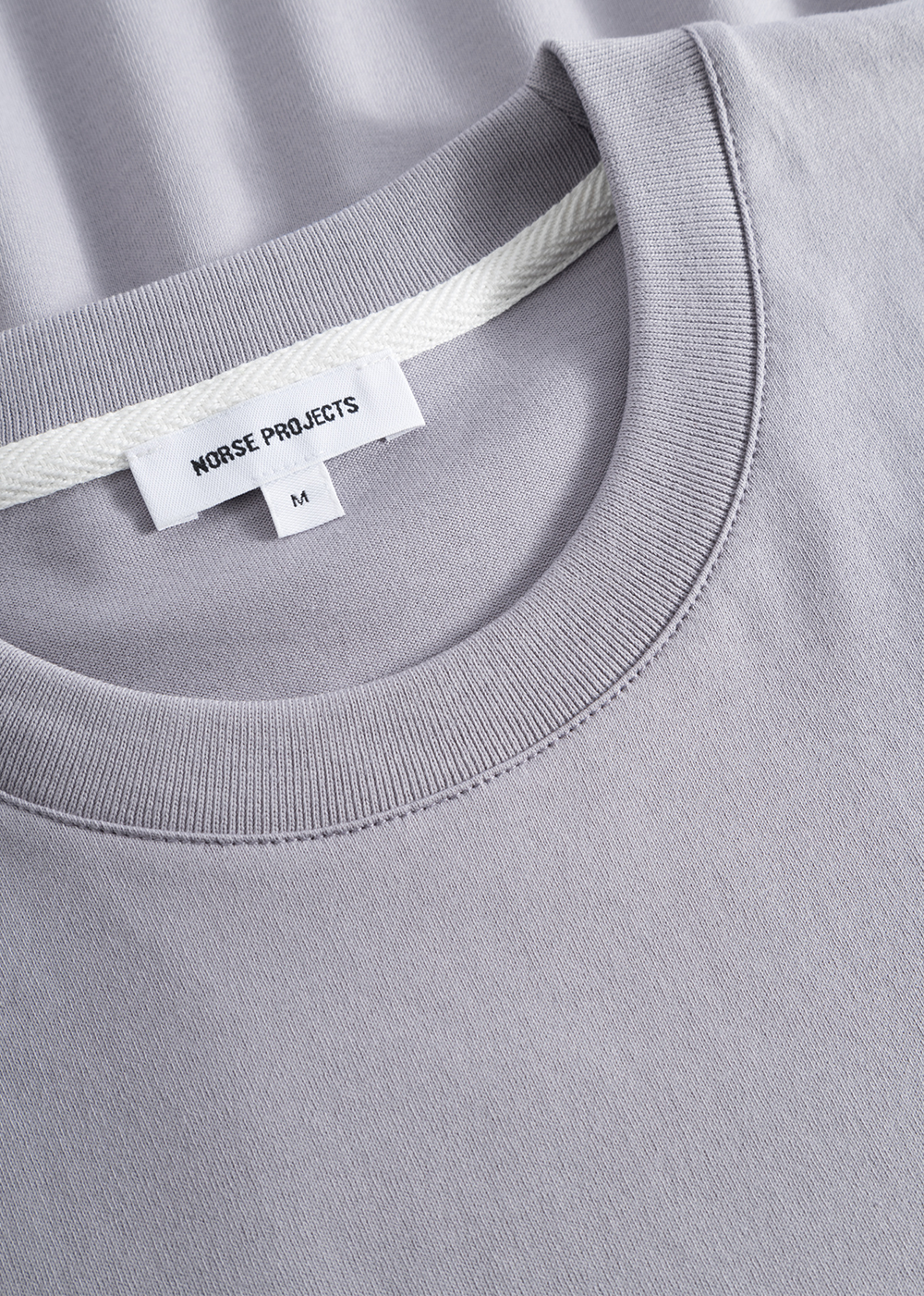 Close up of the Johannes Organic Pocket T-Shirt  in crocus purple showcasing the texture.