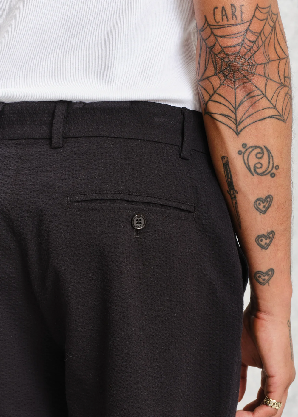 Close up view of the black Alp Seersucker pant from Wax London, showcasing the texture of the cotton blend.