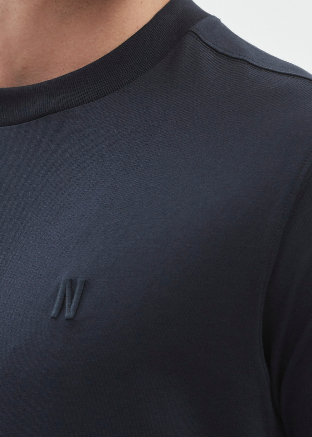 Close up of the embroidered "N" logo  on Johannes Organic T-Shirt by Norse Projects