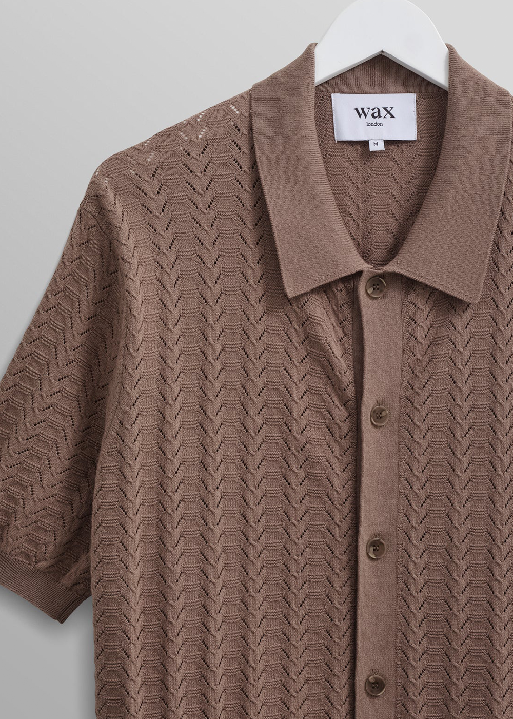 close up view of the Tellaro Polo Shirt by Wax London in Brown, detailing the pointelle stitch feature