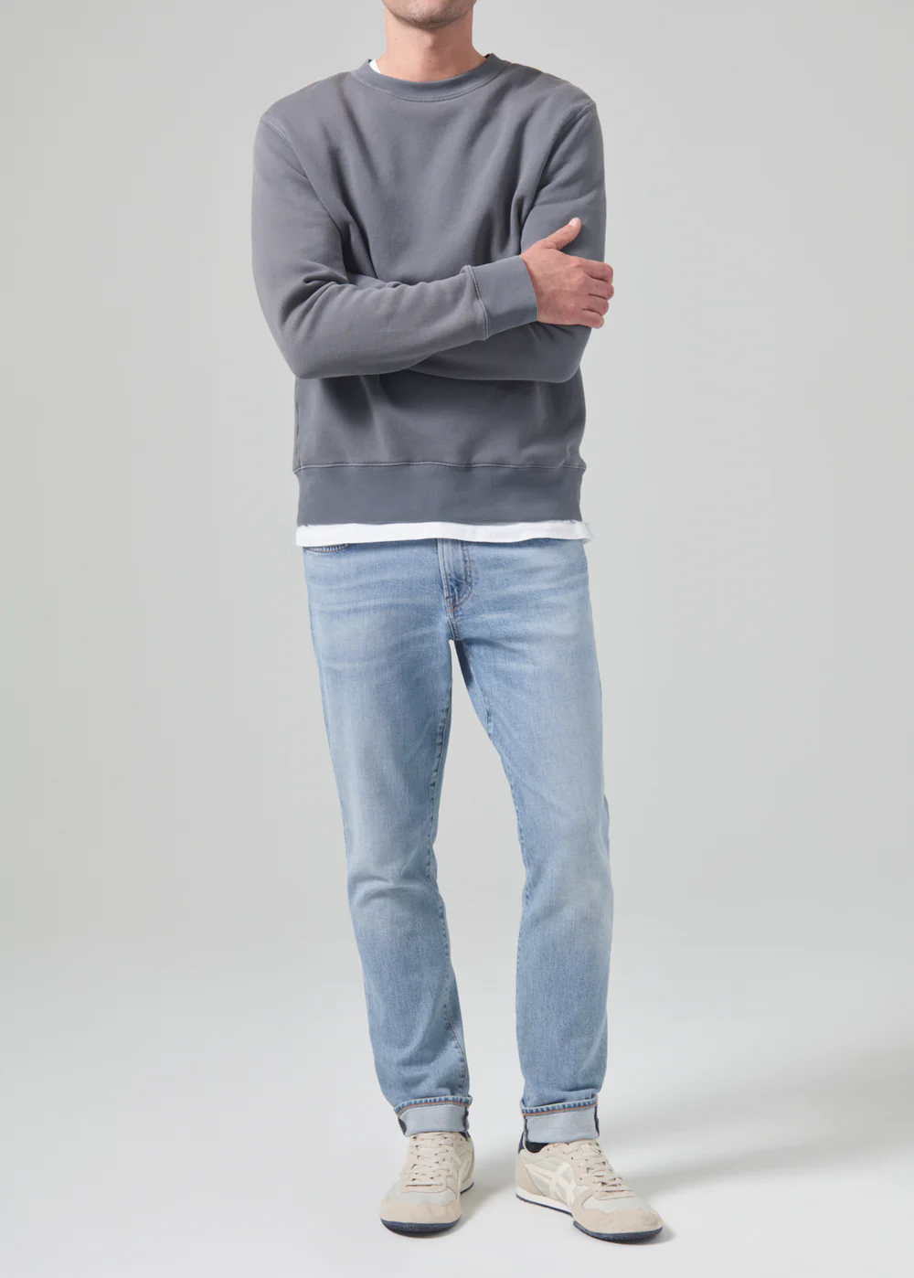 Model wearing the London from Citizens of Humanity in bright light indigo. Showcasing the slim fit jean that fits fuller in the thighs and tapers to the ankle.