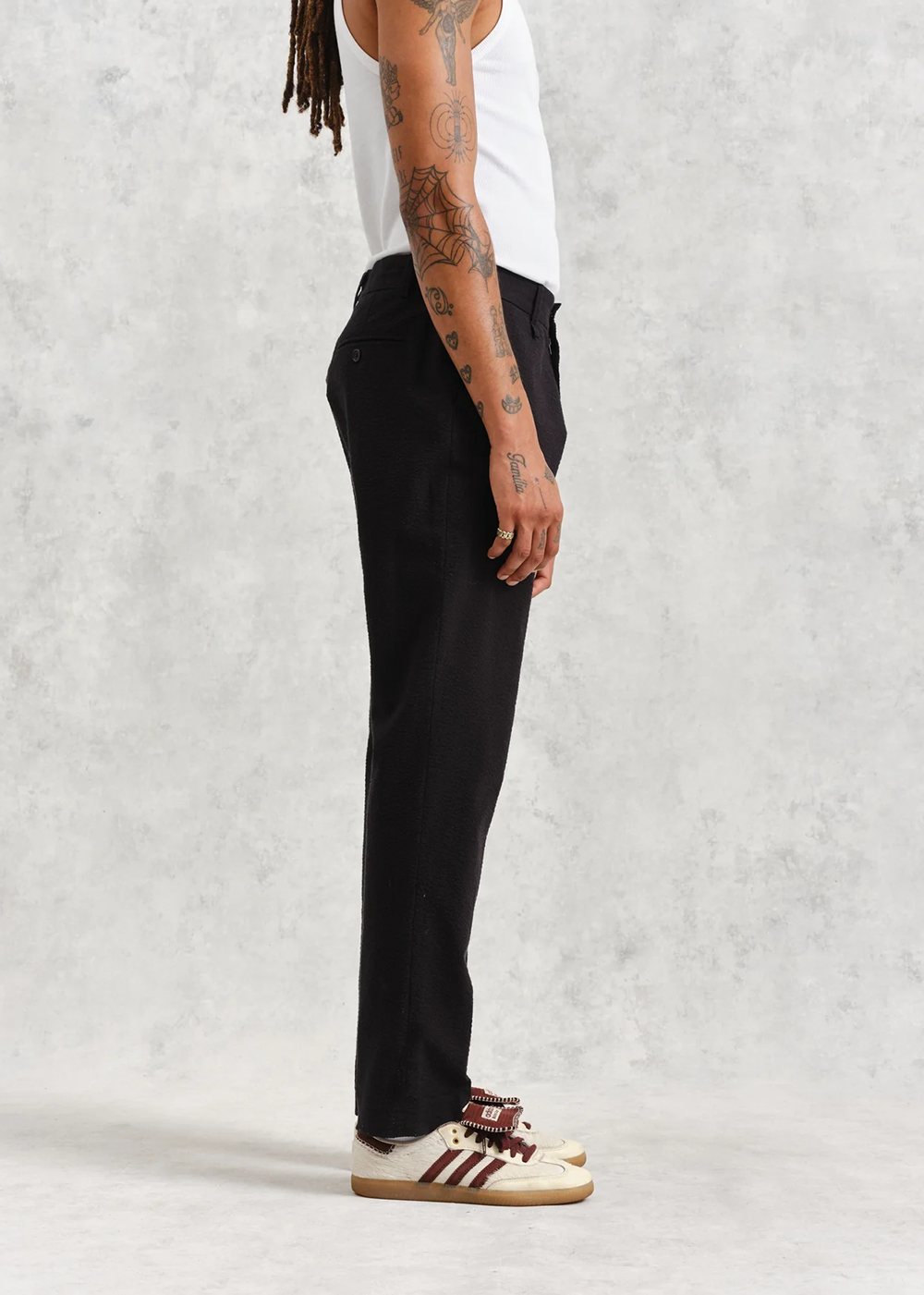 Side view of a model wearing the Alp Seersucker pant , showcasing the straight fit.